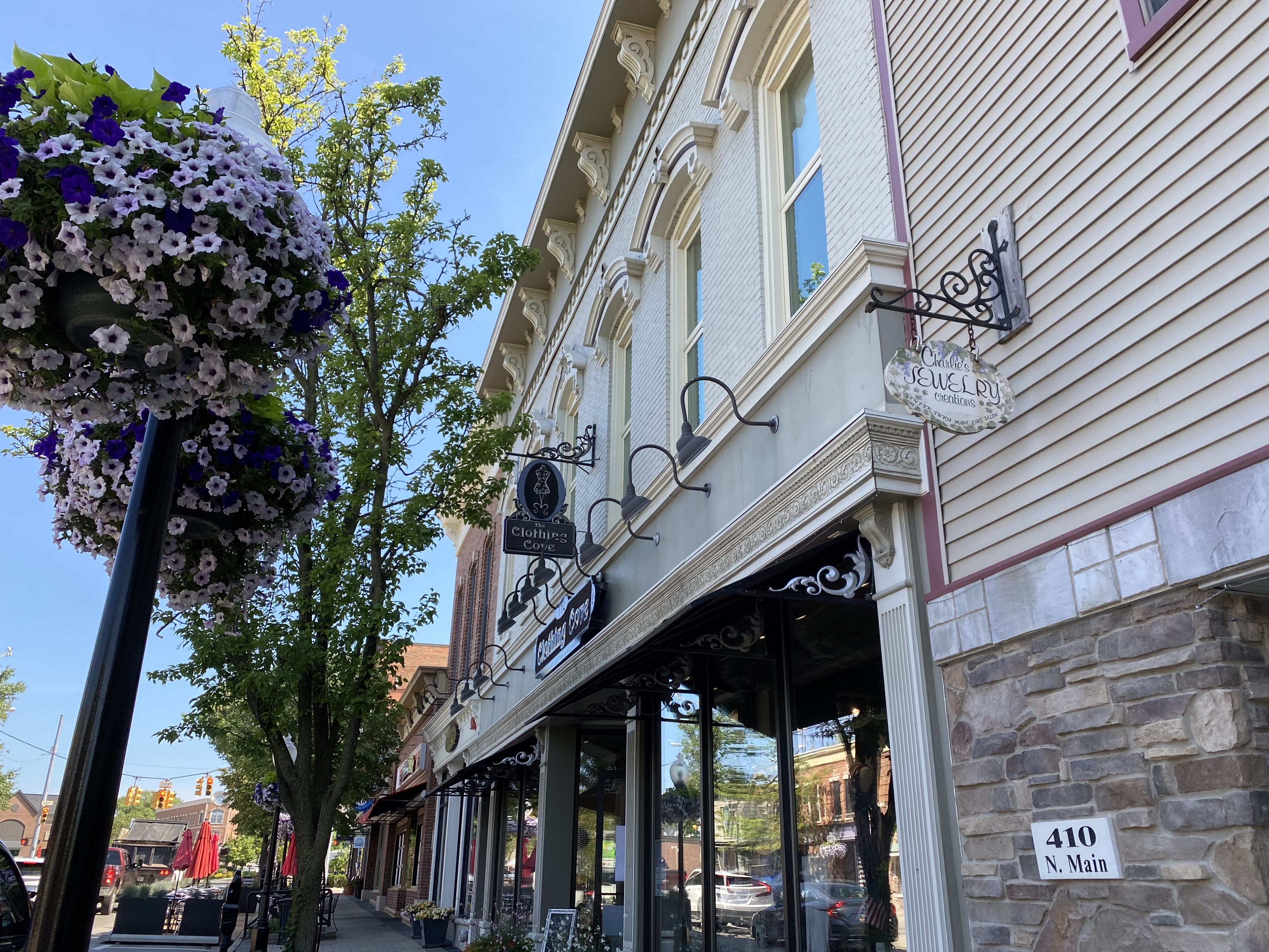 Quaint downtown street with shops and hanging flower baskets