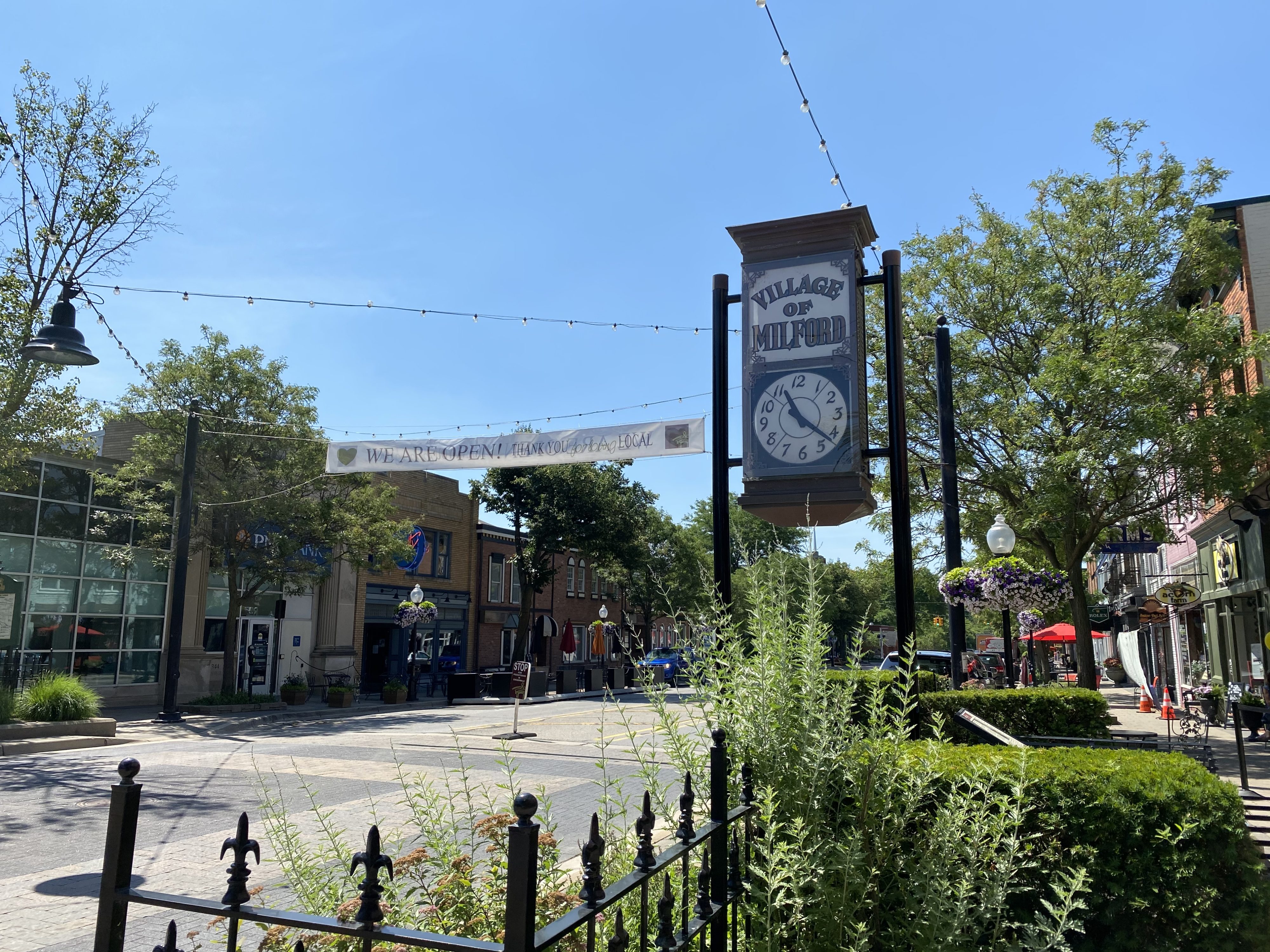Sunny day in vibrant Village of Milford street scene