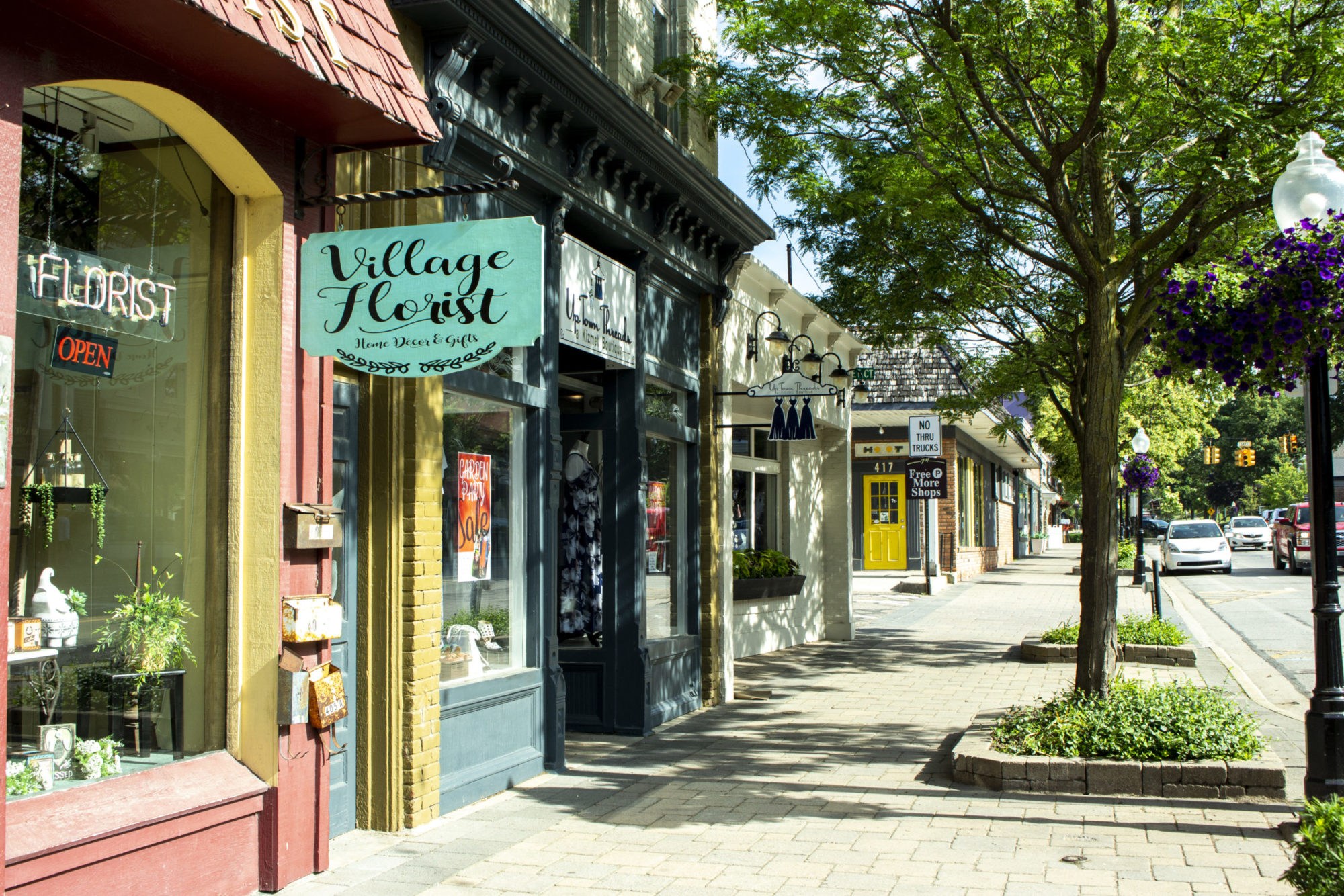 Quaint village street with florist and boutique shops.