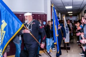 Veterans Day flag procession in school hallway