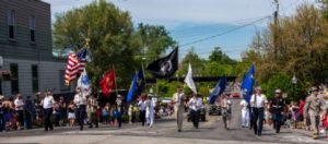 Veterans marching with flags in parade