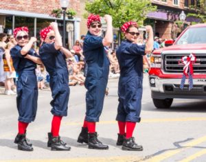 Performers in red, white, and blue at a parade.