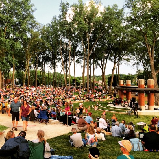 Outdoor concert with audience in park setting