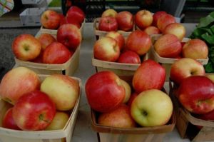 Fresh apples in baskets at a market.