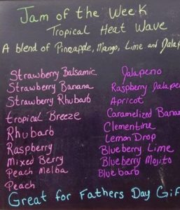 Chalkboard listing assorted jam flavors, weekly special noted.