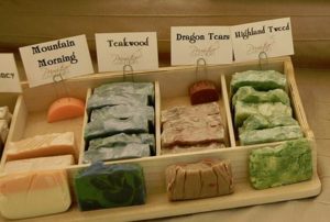 Handcrafted soaps with descriptive names on display.