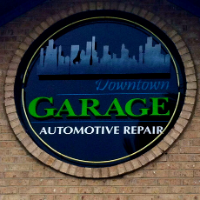 Illuminated garage sign for automotive repairs at night.