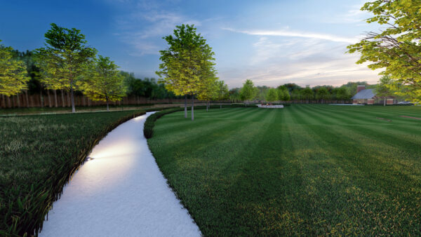 Lush park with illuminated path and green trees at dusk.