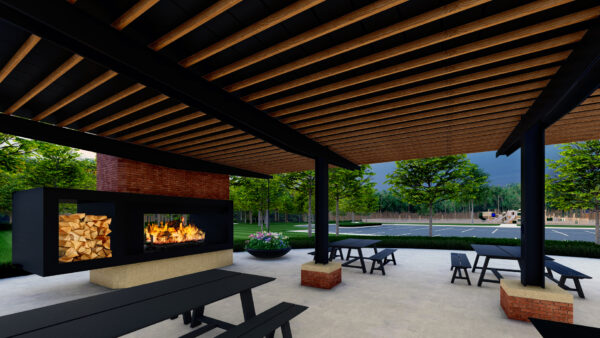 Outdoor patio with fireplace and seating area at dusk.