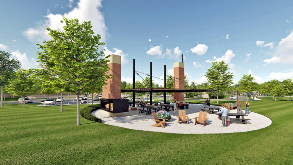 Outdoor park pavilion with seating and fireplace.